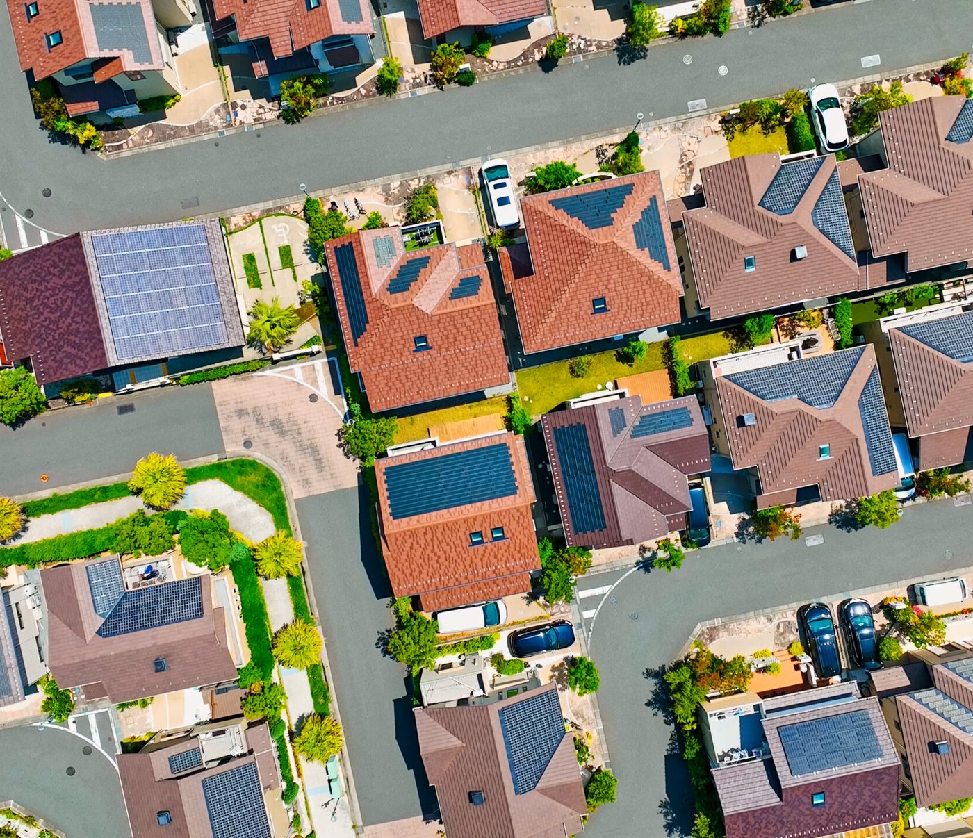 Aerial view of a suburb with solar panels across the rooftops